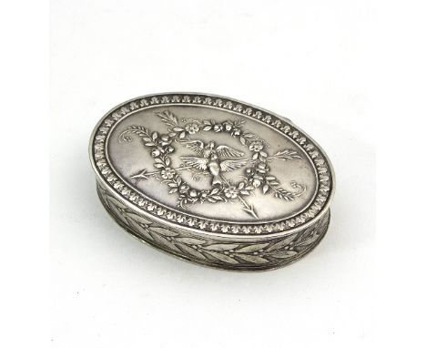 A French oval silver snuff box, 19th Century, the cover decorated birds within a wreath, the sides with a band of leaves, 6.5