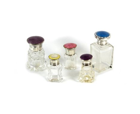Five enamel and silver mounted scent bottles, each with coloured guilloche enamel cover, various sizes/see illustration   Con