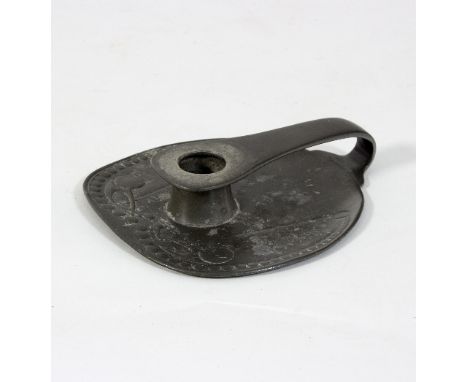 A Tudric pewter candlestick, of Archibald Knox design, with beaded and stylised designs, 19cm wide