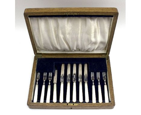 A set of mother-of-pearl handled silver dessert knives and forks, James Dixon & Sons, Sheffield 1933, in a fitted canteen