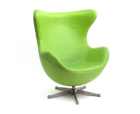 After Arne Jacobsen, an Egg chair, design 1958, the fibreglass shell with green upholstery (lacking seat cushion) on a cast a