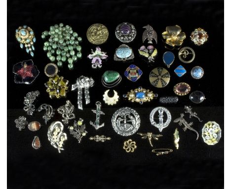A large collection of various silver and gem set brooches, including to a silver brooch in the form of a bird set with an ame