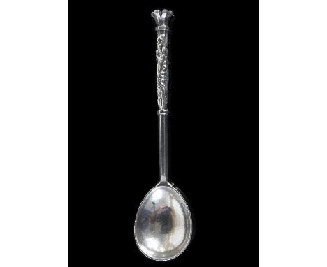 An Omar Ramsden silver spoon, London 1933, with hammered bowl, the handle decorated lily of the valley and a stylised coronet