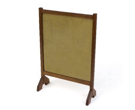 A Cotswold School oak firescreen, in the manner of Sidney Barnsley, glazed central panel to either side, 75cm high