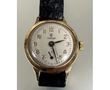 A 9ct gold ladys Tudor (Rolex) manual wind wrist watch with silvered dial and arabic numerals with subsidiaries seconds hand 