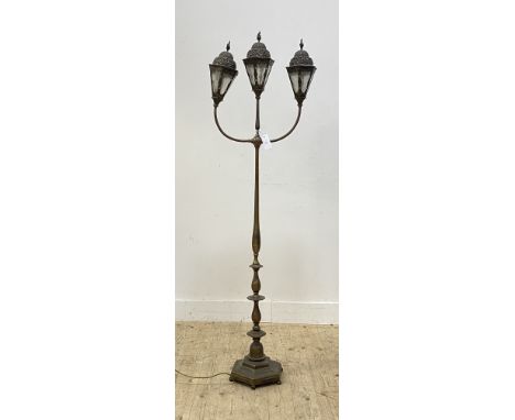 A well cast brass street light style lamp standard, second quarter of the 20th century, with three lanterns with urn finials,