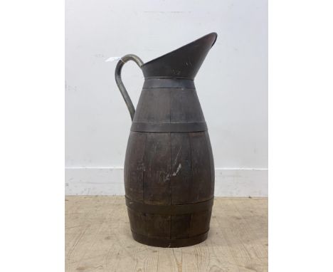 A 19th century coopered oak water jug, with planished copper rim and brass handle, good height for a stick stand. H70cm.&nbsp