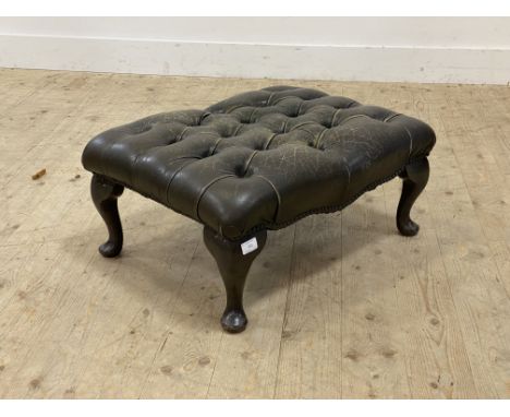 A vintage footstool, upholstered in deep buttoned and studded brown leather, raised on cabriole supports. H30cm, W66cm, D50cm