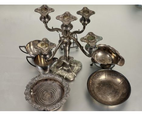 A collection of Epns to include a four division toast rack, 1930s style sugar basin and jug, a Sheffield plated wine coaster 