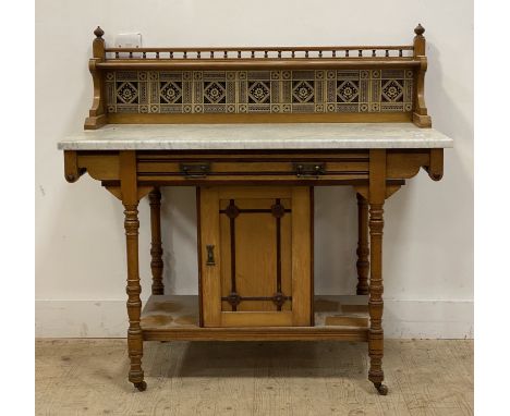 An Aesthetic period ash wash stand, late 19th century, the open shelf with spindle gallery above tile back and marble top, th
