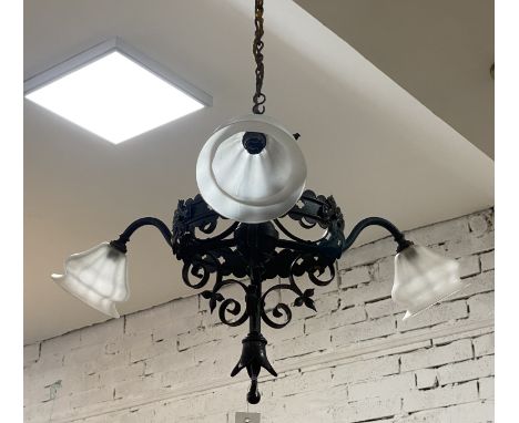 A early 20th century ecclesiastical wrought iron three branch pendent light fitting with three period glass shades. fitting h