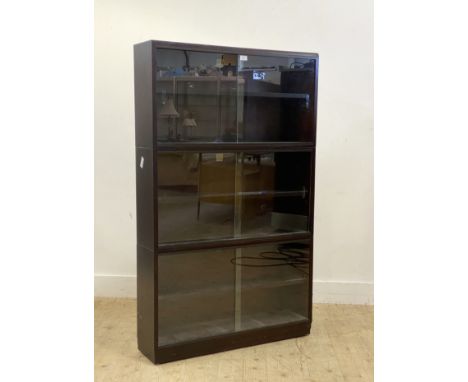 A mahogany three height stacking bookcase, mid 20th century, each section fitted with an adjustable shelf and sliding glass d