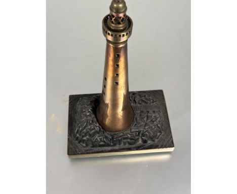 A Edwardian copper tapered column lighthouse lamp base with cast brass pierced light top on naturalistic rock cast metal moun