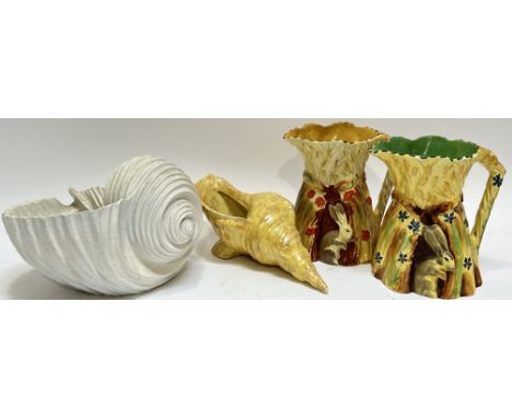 A mixed lot comprising a decorative polymer conch shell (h- 16cm, w- 26cm), a vintage Burleigh pottery conch shell, and two B