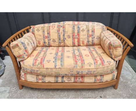 An Ercol two seater settee and matching armchair. 