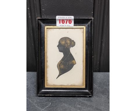 A 19th century silhouette portrait miniature of a lady, with gilt highlights, 10.5 x 6.5cm.&nbsp; 