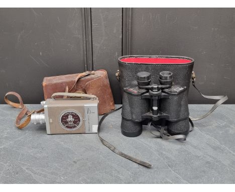 A 16mm cine camera; and a pair of binoculars,&nbsp;each cased.&nbsp;(2) 