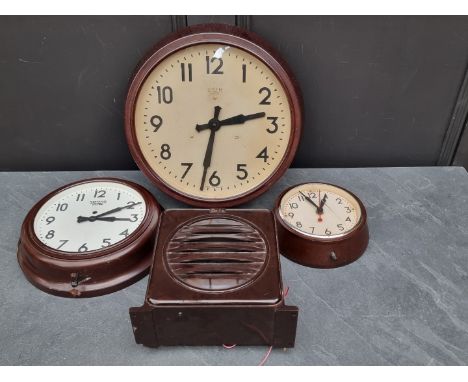 Two 1920s Smiths brown Bakelite wall clocks,&nbsp;largest 37cm diameter; together with another smaller example; and a similar