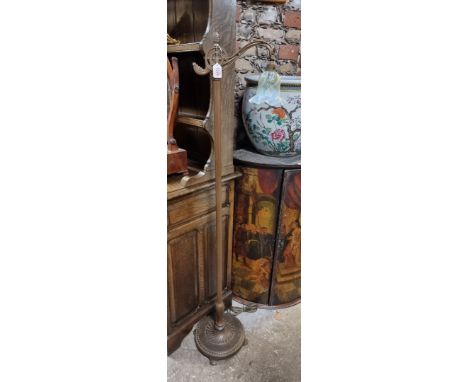 A brass standard lamp, stamped 'Alwyn', with Vaseline glass shade, 141cm high. 