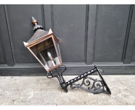 A large black painted wrought iron and copper wall lantern,&nbsp;approx 116cm high.&nbsp; 