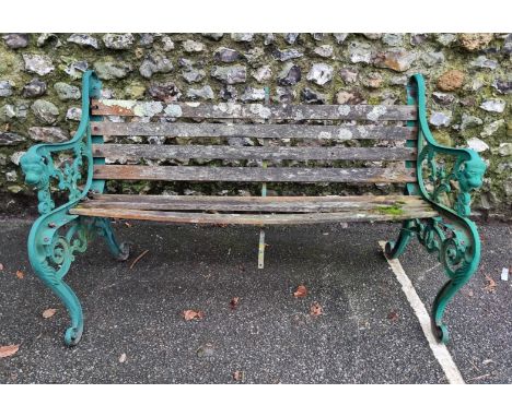 A green painted steel garden bench, (distressed). 