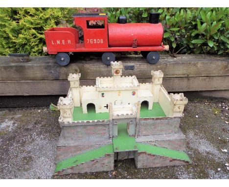 A red wooden push-along Locomotive, 74 cm (length), a model Fort, 38 cm (h) x 61 cm (w) x 41 cm (d) and a small quantity of O