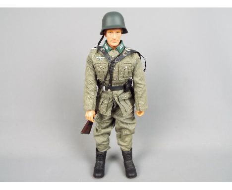 Dragon Models - An unboxed Dragon Models figure of a WW2 German soldier. The 12 inch figure with uniform, helmet, and field e