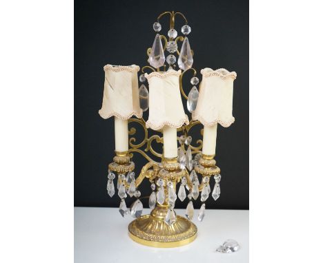 A gilt metal three branch table lamp with glass droplet decoration. 