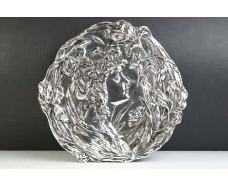 An Art Nouveau silvered ceramic wall plaque. 