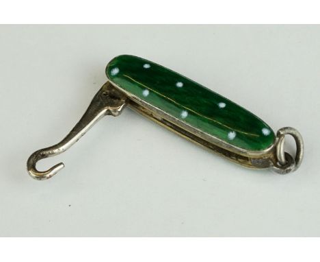 A miniature folding button hook with ornate guilloche enamel decoration. 