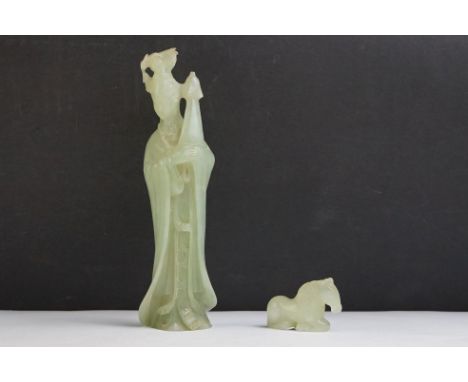 An oriental carved jade figure in traditional dress together with a carved horse. 