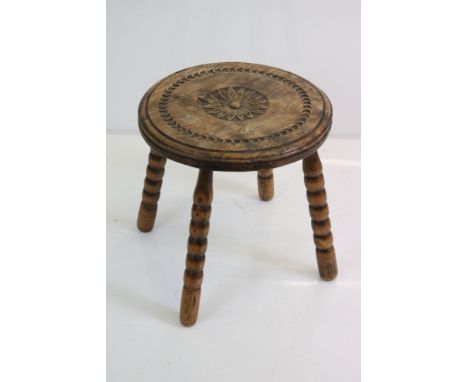 Late 19th / Early 20th century Elm Stool with carved top and four bobbin legs, 34cm diameter x 35cm high 