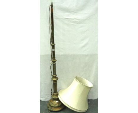 Early 20th century brass standard lamp, the relief cast case supporting a telescopic column, maximum H: 160 cm. Not available