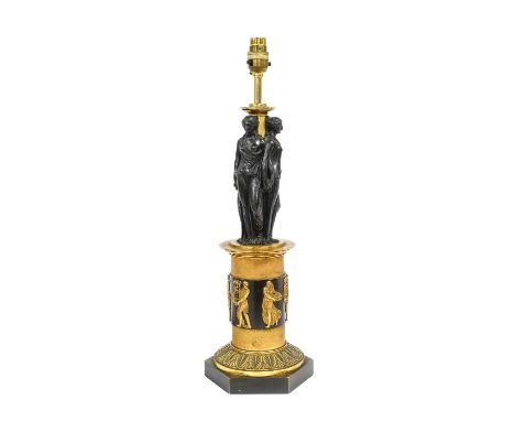 A Gilt and Patinated Bronze Lamp Base, in Empire style, modelled as the Three Graces standing on a cylindrical column applied