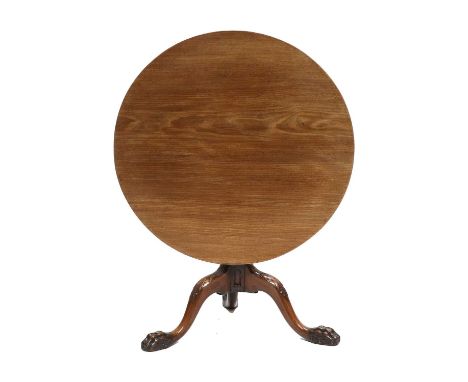 A George III Mahogany Tripod Table, 18th century and later, of broad circular form with tilt-top above a turned vasiform supp