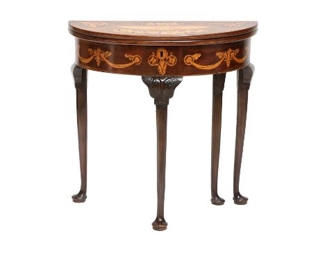 A George III Mahogany and Marquetry-Inlaid Foldover Card Table, richly inlaid with fan patera and flowers, the frieze decorat