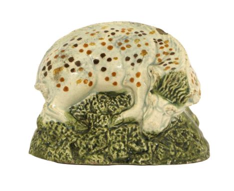A Prattware Figure of a Boar, circa 1800, naturalistically modelled with brown and ochre spots on a green wash mound base 8cm
