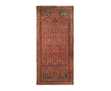Malayir KellehWest Iran, circa 1920The abrashed strawberry Herati field enclosed by stepped indigo spandrels and narrow yello
