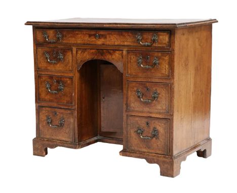 A George II Walnut and Crossbanded Bureau-Table, 2nd quarter 18th century, the moulded top above an oak-lined long drawer wit