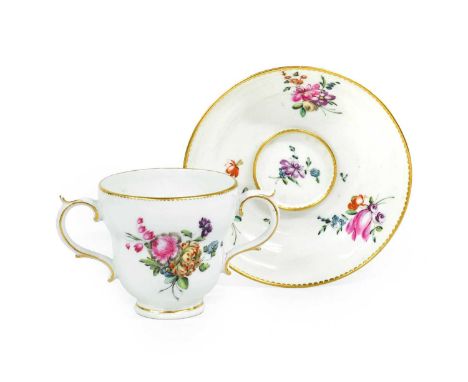 A Chelsea Derby Porcelain Twin-Handled Chocolate Cup and Trembleuse Saucer, circa 1775, of ogee form, painted in the manner o