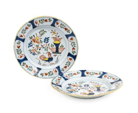 A Pair of English Delft Plates, probably Vauxhall, circa 1730, painted in colours with a cockerel and basket of flowers among