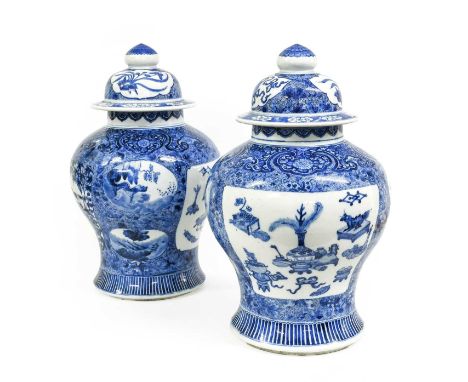 A Pair of Chinese Porcelain Baluster Jars and Covers, in Kangxi style, painted in underglaze blue with precious objects and f