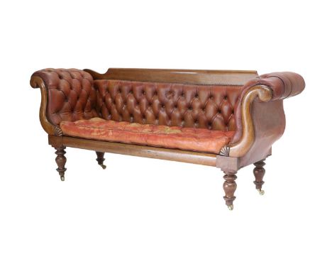 A George IV Mahogany-Framed Scroll-End Sofa, 2nd quarter 19th century, recovered in close-nailed buttoned red leather, with o
