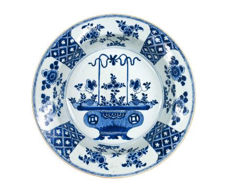 A Chinese Porcelain Basin, Kangxi, of circular form, painted in underglaze blue with a basket of flowers within a geometric b