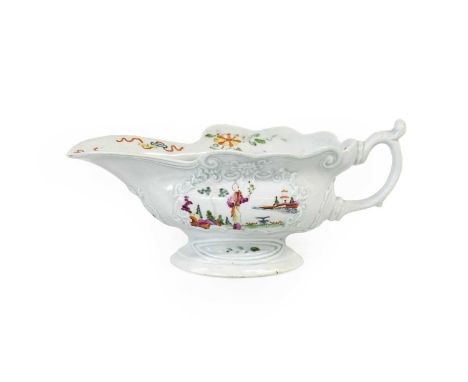 A Worcester Porcelain High-Footed Sauceboat, circa 1755, painted in famille verte-type enamels with a "Long Eliza" in a fence