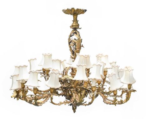 A Louis XV-Style Twenty-Eight-Light Gilt-Bronze Chandelier, late 19th century, the stem modelled as acanthus leaves and issui