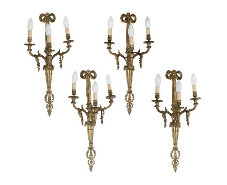 A Set of Four French Ormolu Three-Light Wall Appliques, late 19th/early 20th century, with ribbon-tied backplate supporting a