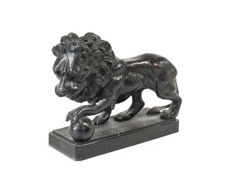 After the Antique: A Bronze Medici Lion, standing with its left paw on a ball on a rectangular plinth34cm long