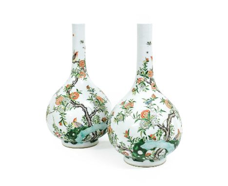 A Pair of Chinese Porcelain Bottle Vases, in Kangxi style, painted in famille verte enamels with birds perched amongst flower