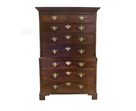 A George III Mahogany Chest on Chest, late 18th century, the dentil cornice above a blind fret carved frieze and two short ov